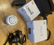 Беззеркальная камера Nikon S1 с двумя объективами Nikkor 11-27,5 мм F3.5